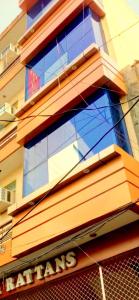 a building with glass windows on the side of it at Hotel Rattans Regency in Roorkee