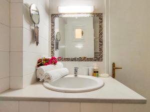 a bathroom with a sink and a mirror at Al Mar in Skiathos
