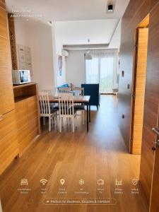 a kitchen and dining room with a table and chairs at Luxury Budva Apartment in Budva