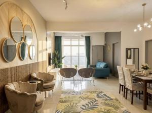 a living room with a table and chairs and a dining room at DG HomestayMuslim Putrajaya - Near Alamanda in Putrajaya