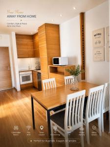 a kitchen and dining room with a wooden table and chairs at Luxury Budva Apartment in Budva
