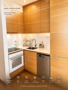a kitchen with wooden cabinets and a sink at Luxury Budva Apartment in Budva +10 photos