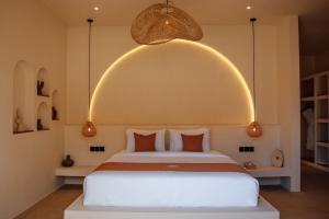 a bedroom with a large bed with an arch above it at Miliyana Boutique Hotel - Adults Only in Kuta Lombok