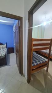 a room with a bunk bed and a door to a bedroom at appart near the Airport and beach tanger in Tangier