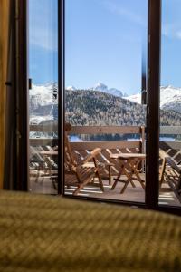 a view of a balcony with a view of snow covered mountains at Hotel Rosatsch Residence in Pontresina