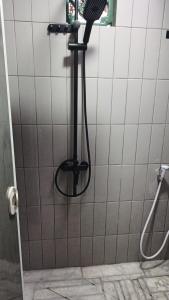 a shower with a shower head in a bathroom at Omah Masayu in Yogyakarta +19 photos