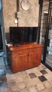 a wooden dresser with a flat screen tv on top at Omah Masayu in Yogyakarta