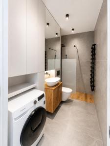 a bathroom with a washing machine and a toilet at APARTAMENT 4 bed 2 room WARSAW in Warsaw