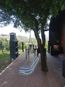 a hammock hanging from a tree on a patio at Refúgio Da Pinheira in Marco de Canaveses