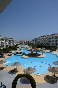 a view of a large swimming pool with umbrellas at Sharm Hills Azure Suite Topview in Sharm El Sheikh +289 photos