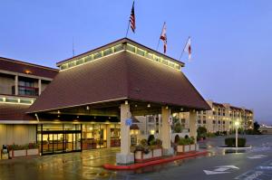 a hotel with a building with flags on top of it at Red Lion Hotel Eureka in Eureka