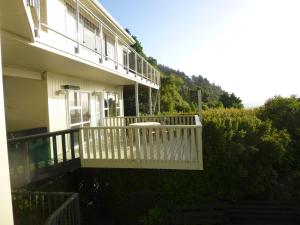 a house with a porch with a white deck at Breakaway at York Bay in Days Bay