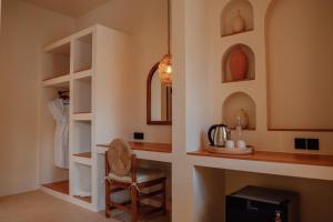 a room with a desk and a chair in a room at Miliyana Boutique Hotel - Adults Only in Kuta Lombok