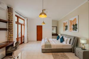 a living room with a bed and a couch at Boutique Dinu in Kandy +28 photos