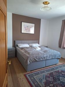a bedroom with a bed in a room with a rug at BlumentrittAppartment in Sankt Aegyd am Neuwalde
