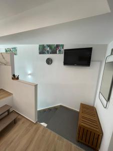 a room with a flat screen tv on a wall at Casa XX Settembre Deluxe in Misterbianco