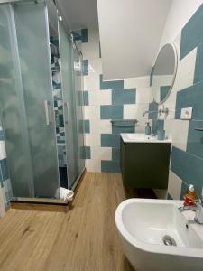 a bathroom with a shower and a sink and a toilet at Casa XX Settembre Deluxe in Misterbianco