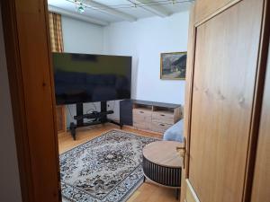 a living room with a flat screen tv and a living room at BlumentrittAppartment in Sankt Aegyd am Neuwalde