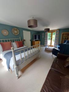 a bedroom with a bed and a living room at The Hen Den in Ludlow