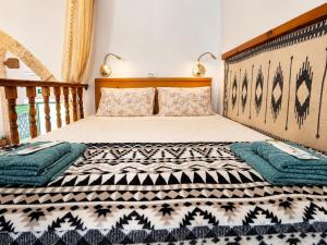 a bedroom with a bed with two pillows on it at Floura's Kamariko - Authentic Rhodian Village House in Archangelos