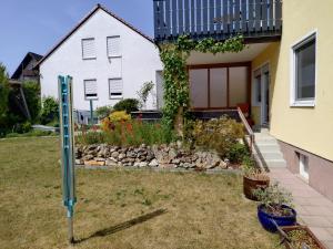 a house with a sign in front of a yard at FEWO Stephan Grünewald in Gunzenhausen +2 photos