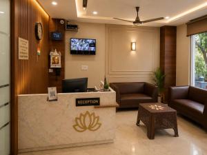 a reception lobby with a reception desk and a television at Hotel Lotus Palace in Lucknow