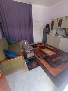 a living room with a couch and a table at Small home aeroport in Zakhmat