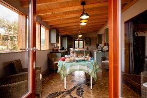a table in a kitchen with a table cloth on it at Chambres d'hôtes Naturistes (Nudiste) "Cabanadelsol" - Adults Only in Monte da Charneca