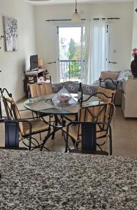 a living room with a table and chairs at Sunset Green 03 in Paphos