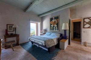 a bedroom with a large bed and a window at La Terrazza di Rivoria - Vue magique & Terrasse in Masera