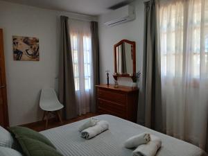 a bedroom with a bed with towels on it at Villa Moll in Cala Morell +43 photos
