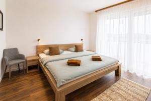 a bedroom with a bed with two bags on it at TRITA SK - Belanka in Spišská Belá