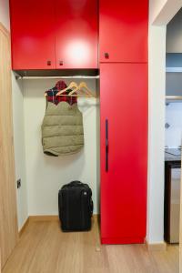 a room with a red cabinet and a bag at Olympia 3 in Xanthi