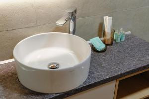 a white sink on a counter in a bathroom at Olympia 3 in Xanthi