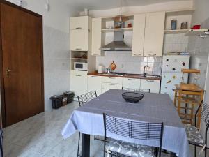 a kitchen with a table with a blue table cloth on it at Casa Cordara Apartment in Nizza Monferrato