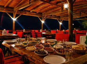 a table with many plates of food on it at Assos Plus in Ayvacık