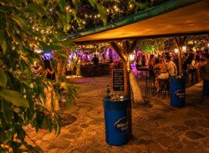 a group of people sitting at tables at a party at Assos Plus in Ayvacık