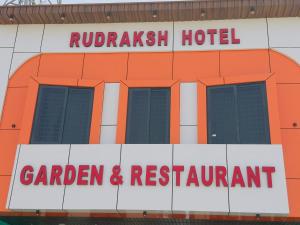 an orange hotel with a sign in front of it at Rudraksh Hotel & Resturant in Lordi +5 photos