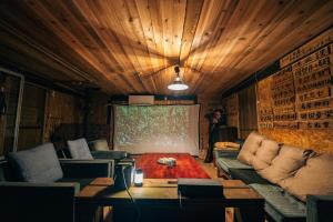 a living room with a couch and a table at 古民家宿まるもり in Wada