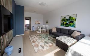 a living room with a couch and a table at Saimaa Design, lake view, AC, Wifi in Savonlinna