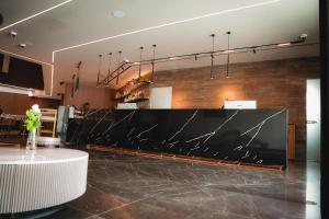 a lobby with a large black marble counter at Serbellas Boutique Hotel in Paphos
