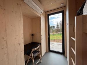 a small room with a desk and a window at Chalet WaldZeit in Weiskirchen +18 photos