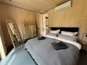 a bedroom with a bed with two towels on it at Chalet WaldZeit in Weiskirchen