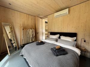 a bedroom with a large bed with towels on it at Chalet WaldZeit in Weiskirchen