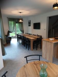 a dining room with a large wooden table and chairs at Pokoje Agnieszka in Pollnow