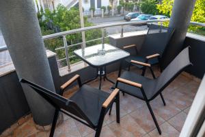 a balcony with a table and chairs on a balcony at Rexha Apartments in Ulcinj