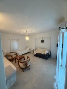 a living room with a bed and a table at White House with Sea View in Ambelas