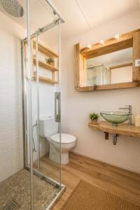 a bathroom with a shower and a toilet and a sink at Apartamentos Es Cupina in La Mola +48 photos