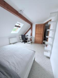 a bedroom with a bed and a spiral staircase at 185 m duplex with pool near Strasbourg in Ittenheim +47 photos