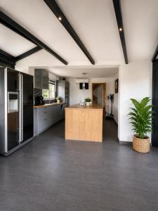 a kitchen with a island in the middle of a room at 185 m duplex with pool near Strasbourg in Ittenheim